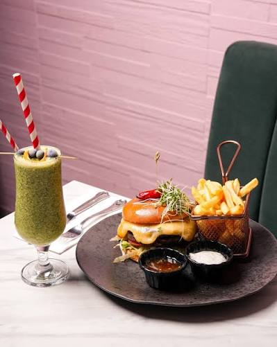 Burger and fries with a green smoothie